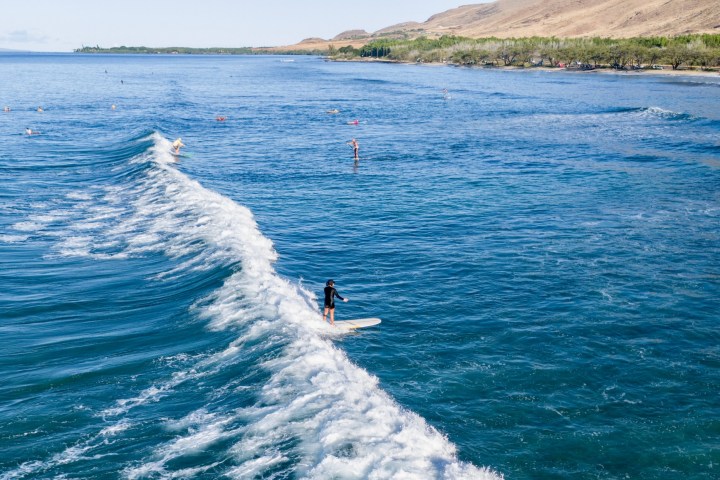 a man riding a wave on top of a body of water